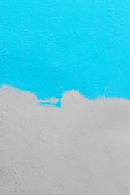 Freshly painted interior wall with cyan blue accents in a modern home.