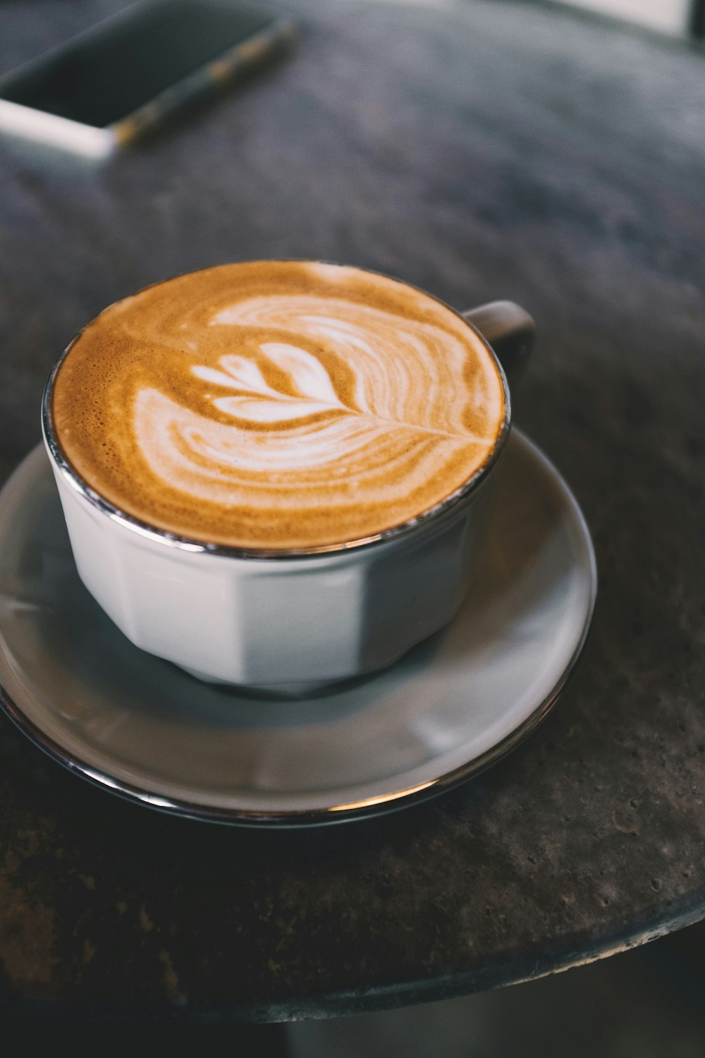 latte filled teacup on saucer