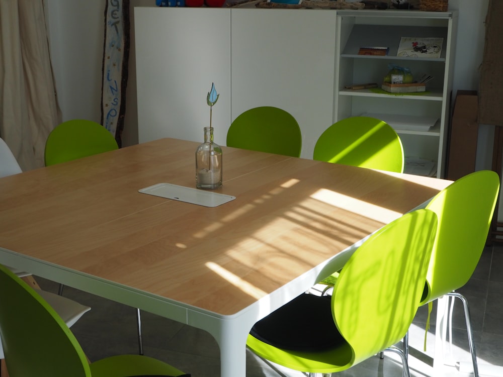 flower vase on table with empty chairs