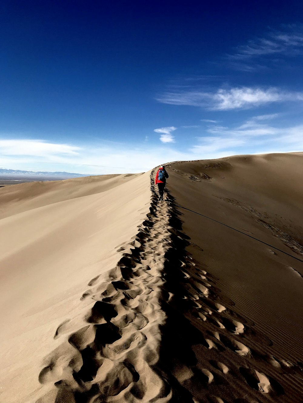 person walking on desert at daytime