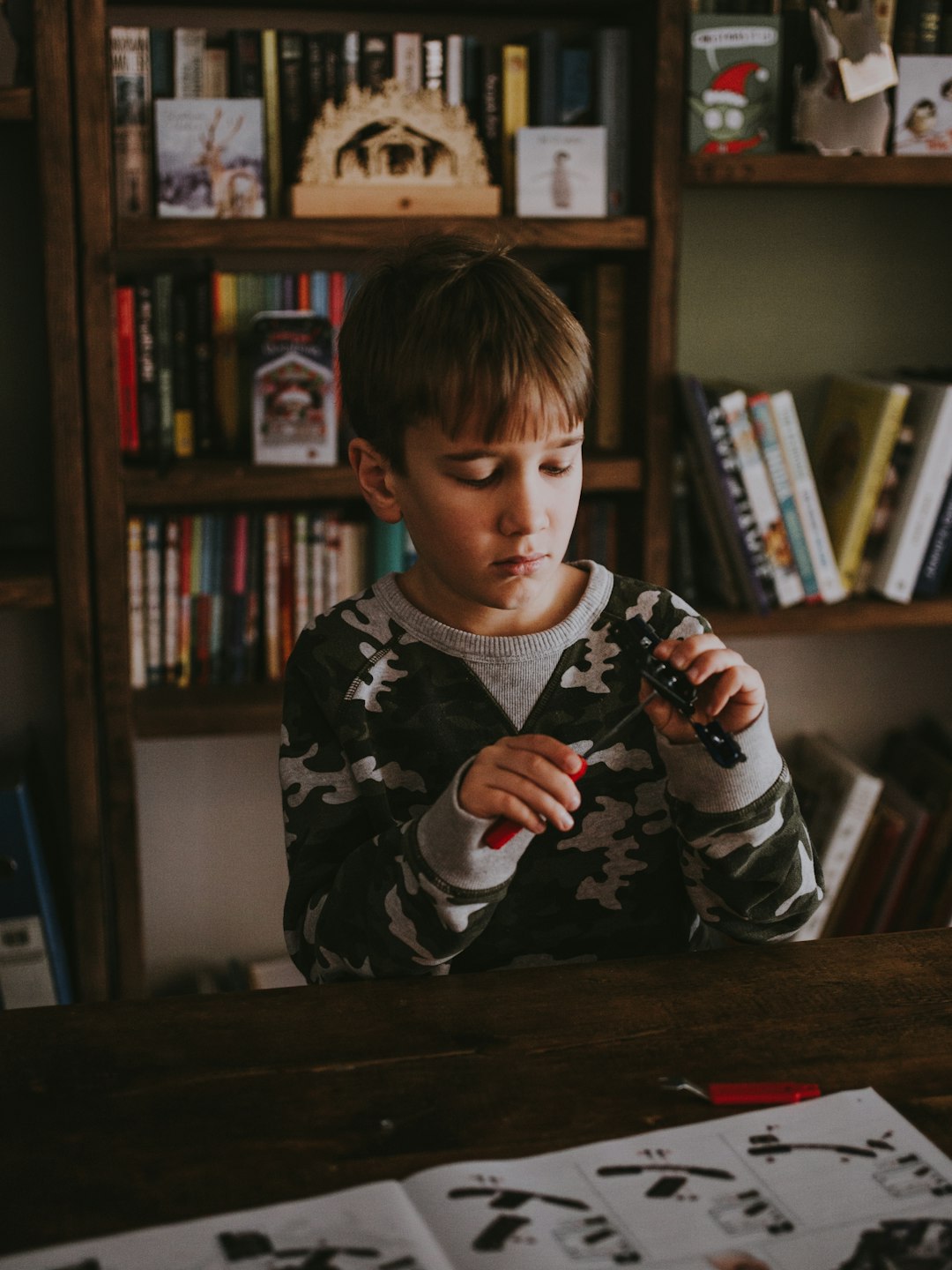 boy behind table