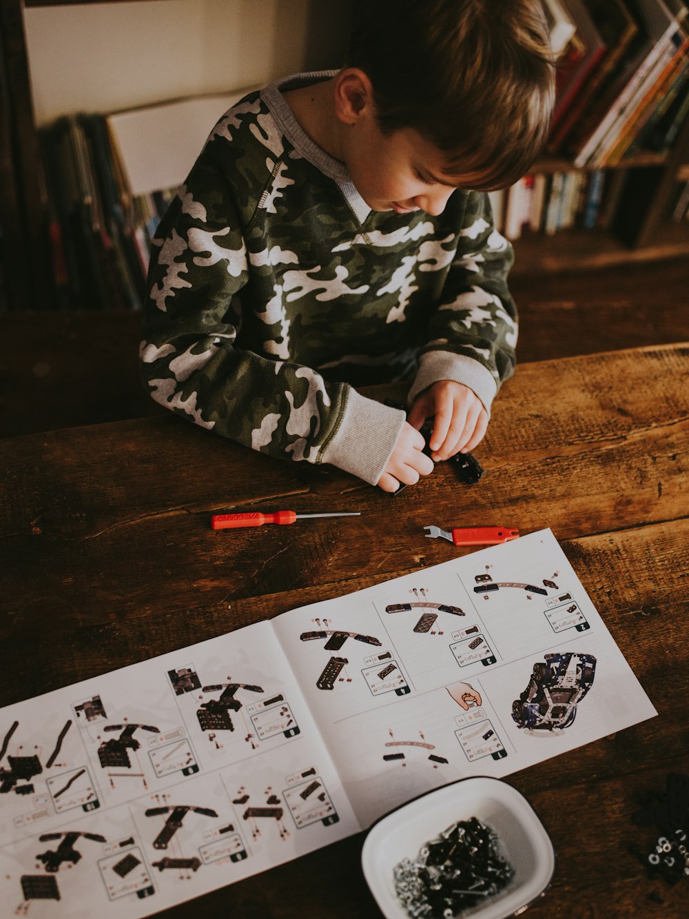 child sitting near table