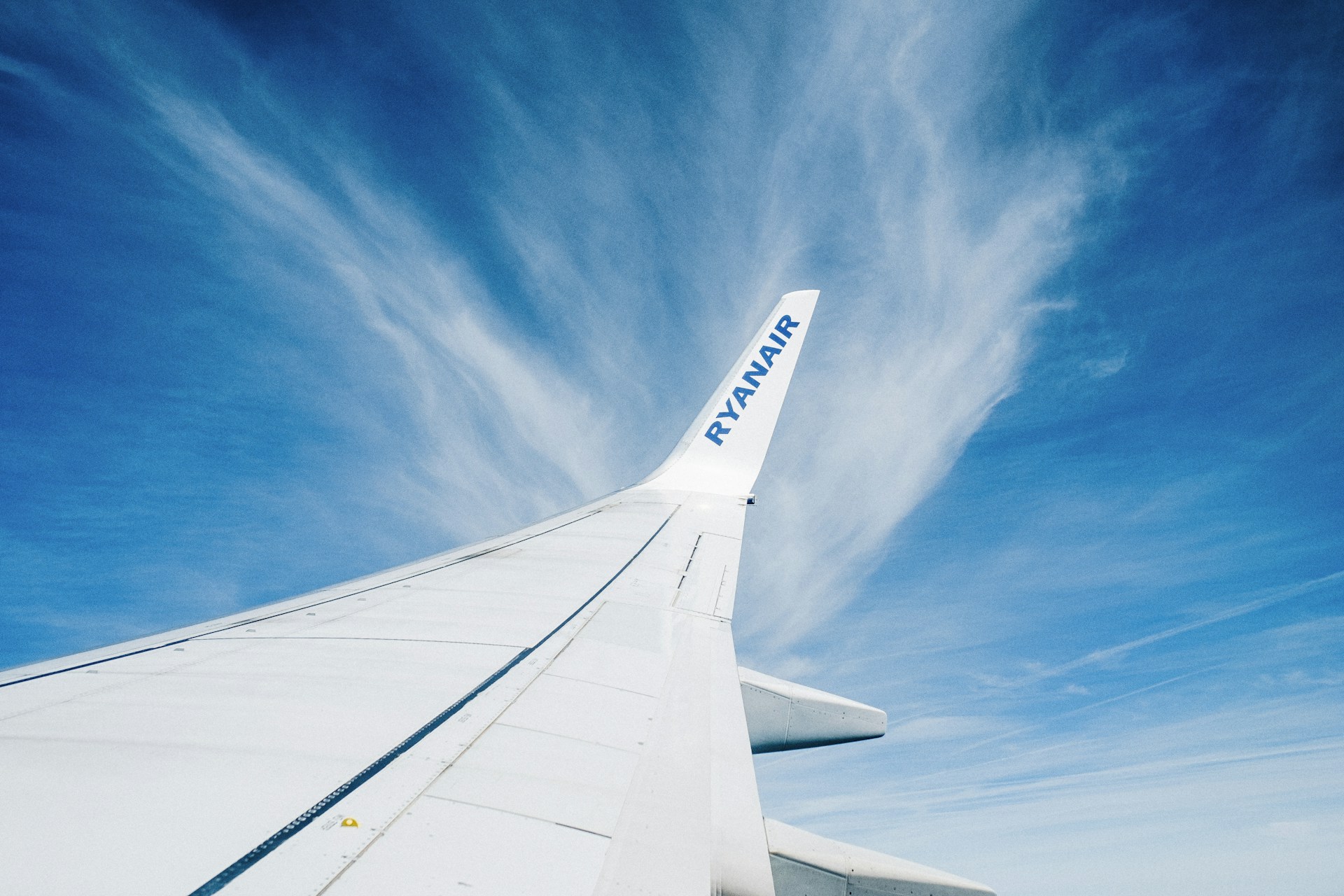 woman wearing yellow long-sleeved dress under white clouds and blue sky during daytime