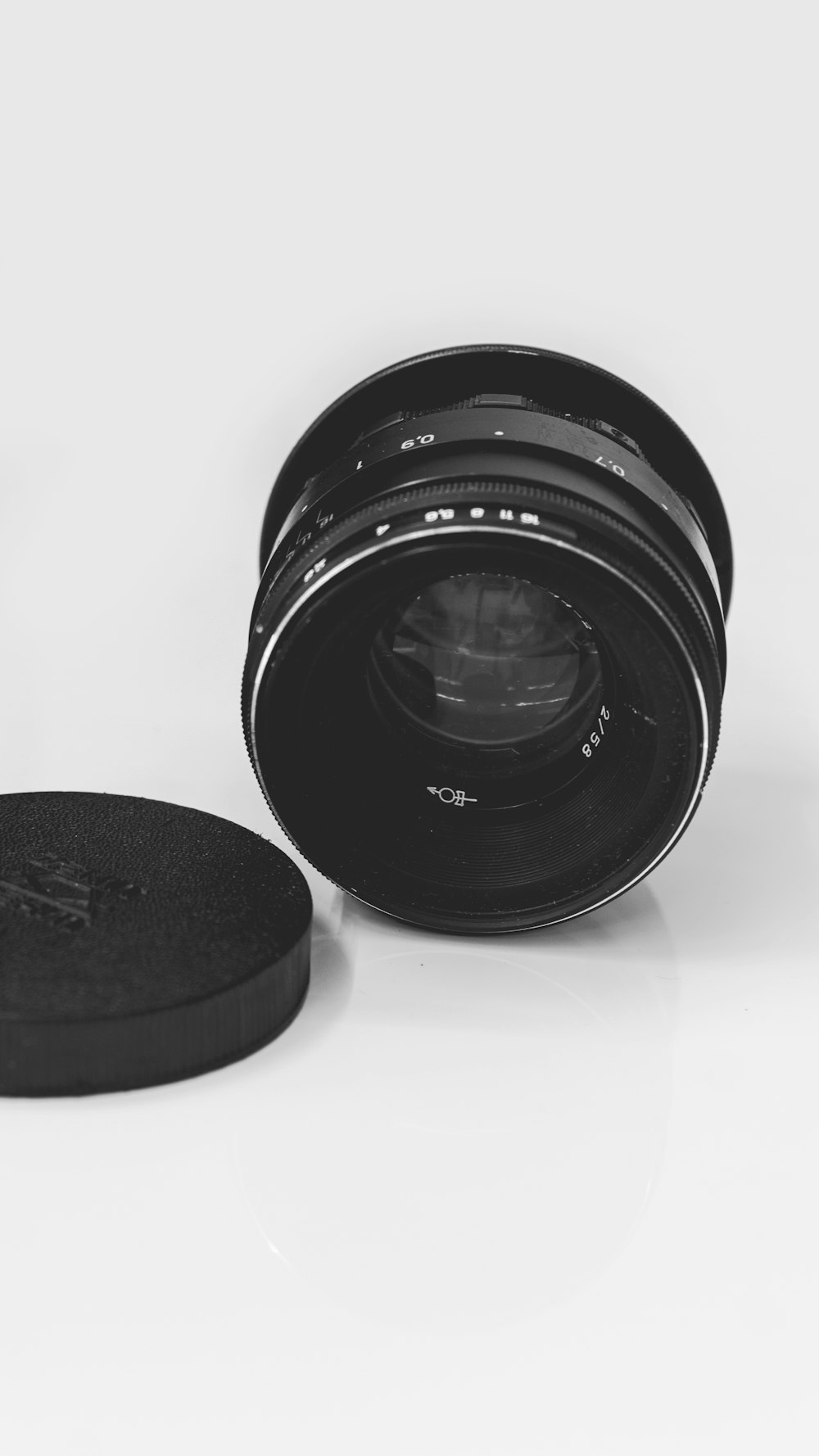 black camera lens on white surface