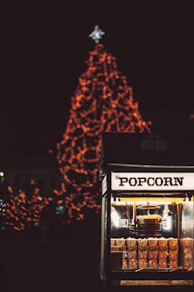 Festive popcorn machine glowing warmly at a lively outdoor party