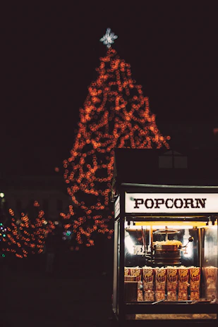 Festive popcorn machine glowing warmly at a lively outdoor party