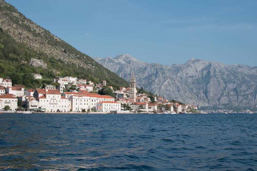 white buildings near body of water at daytime