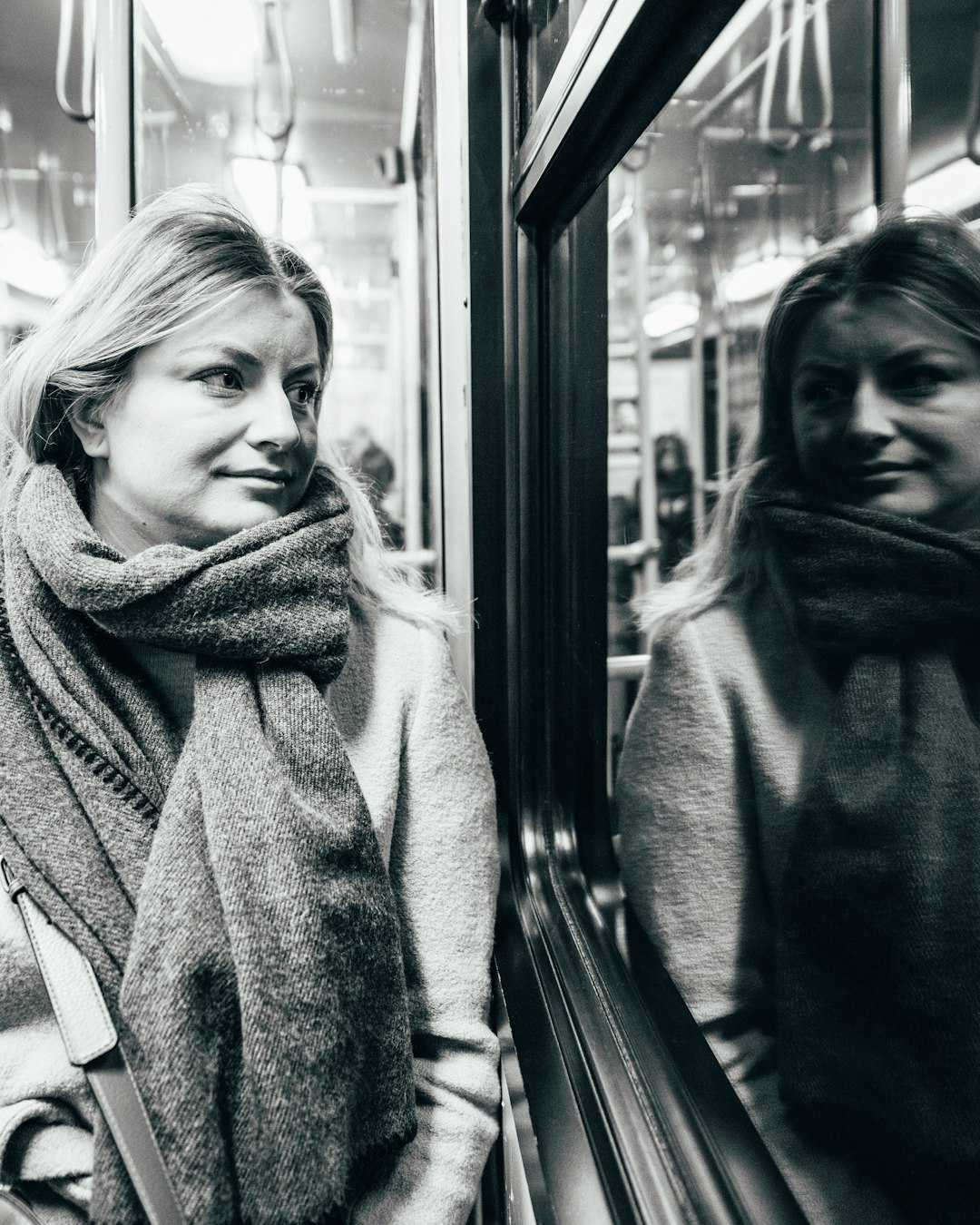 grayscale photography of woman inside train