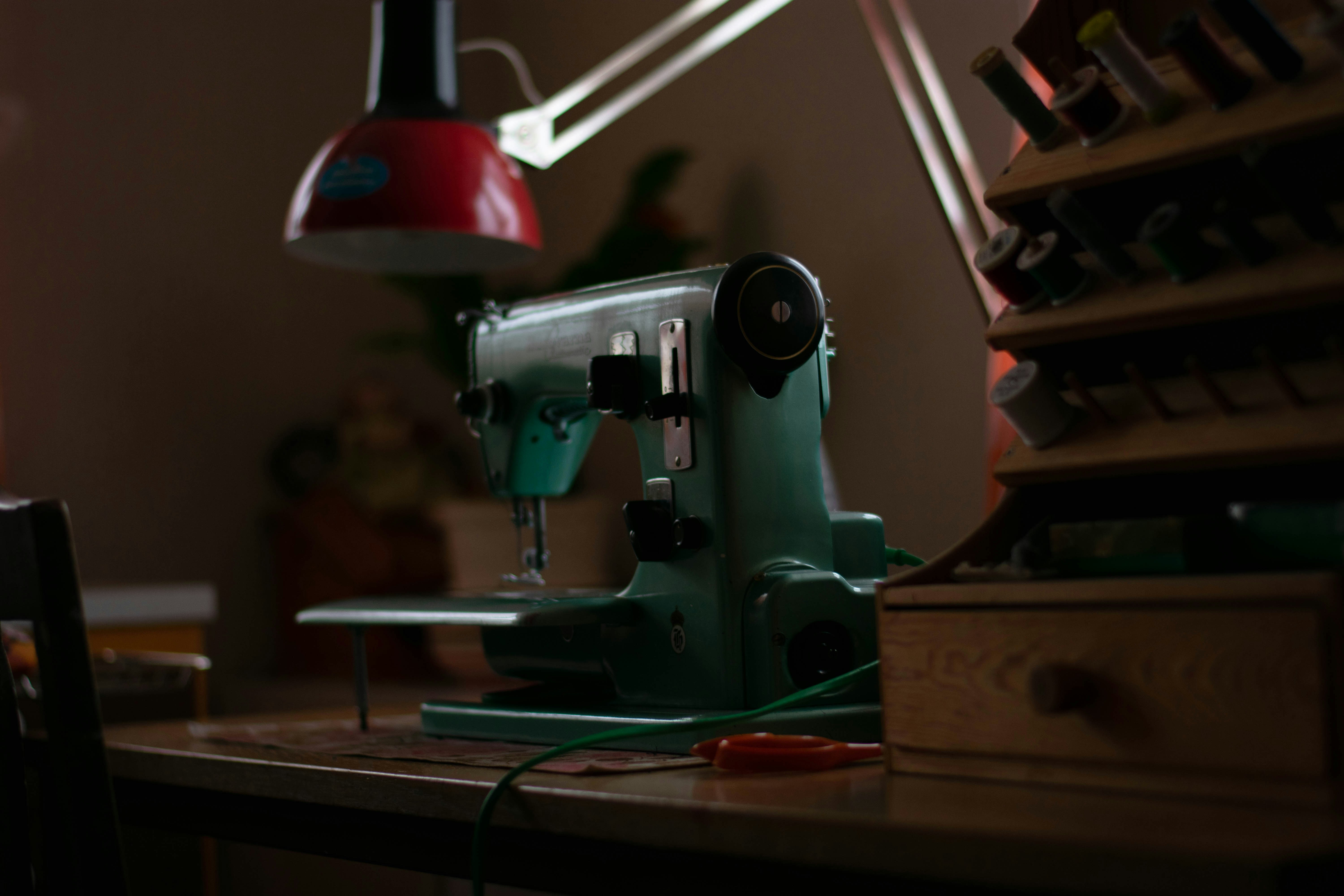 Green vintage sewing machine on work table