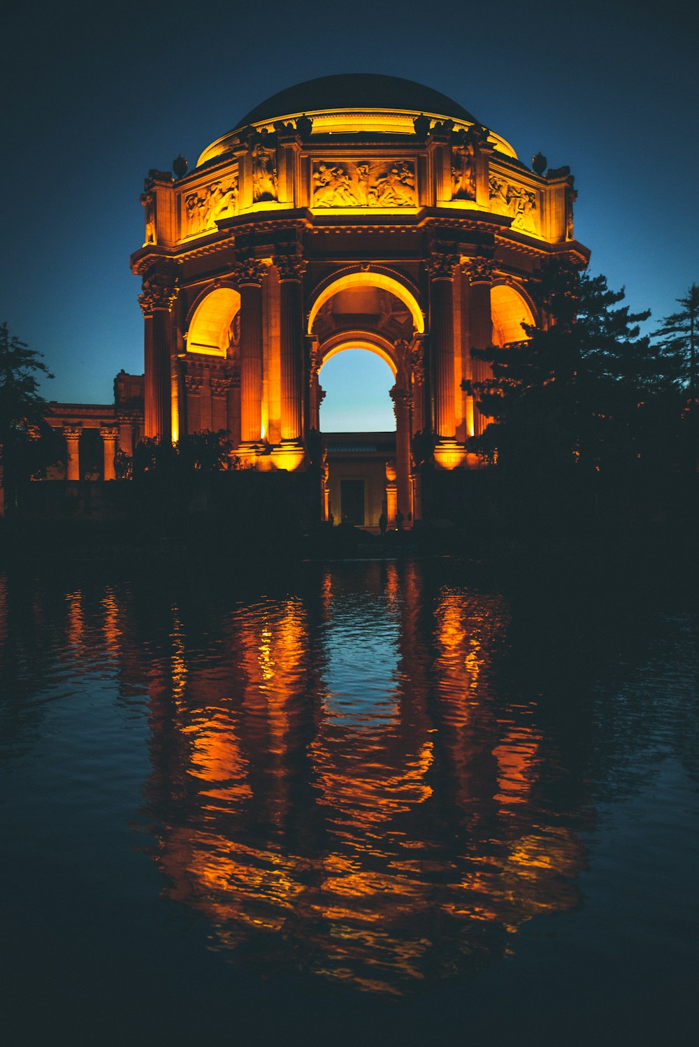 concrete arch with yellow light at night