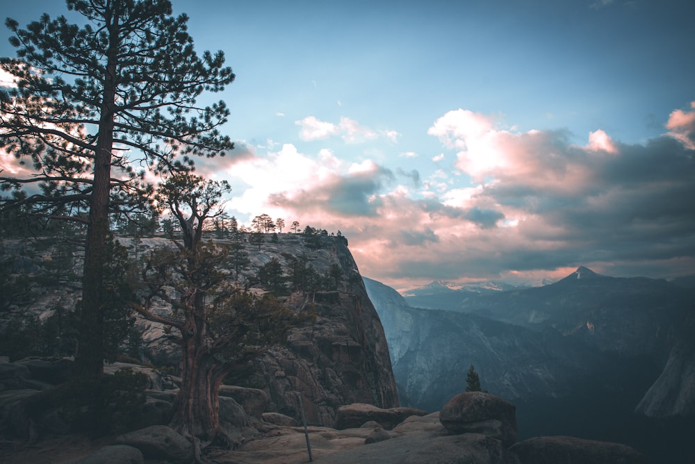 rock cliff under blue and white sky