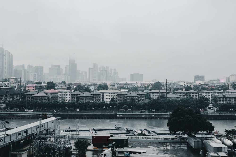 grayscale photography of buildings and river