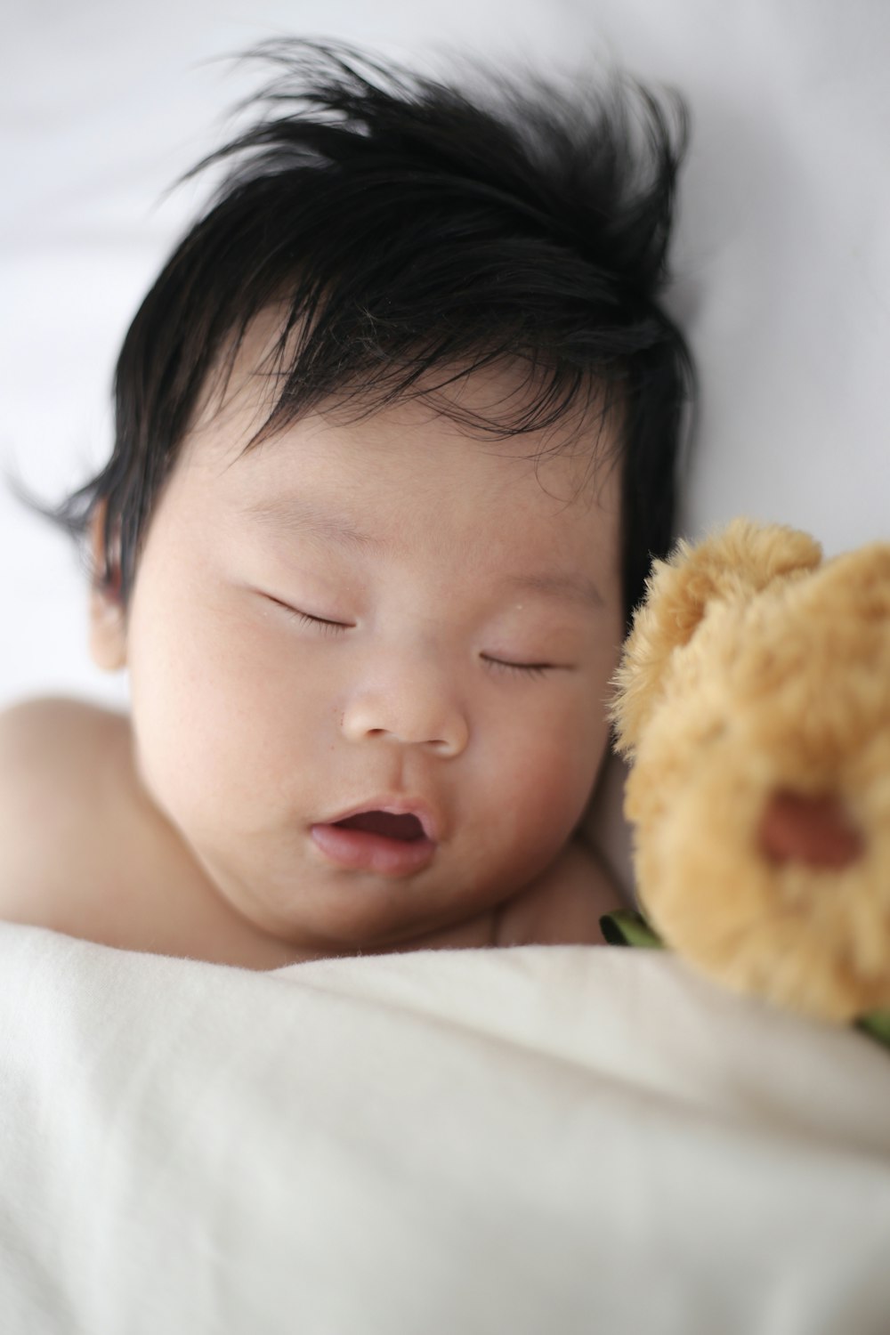 baby sleeping on pillow