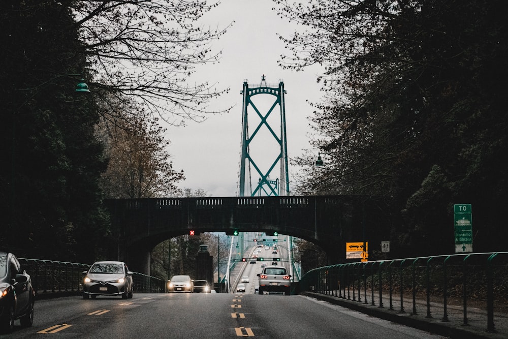 cars on road under bridge