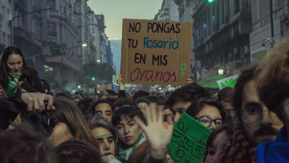 crowd of people at street beside concrete buildings