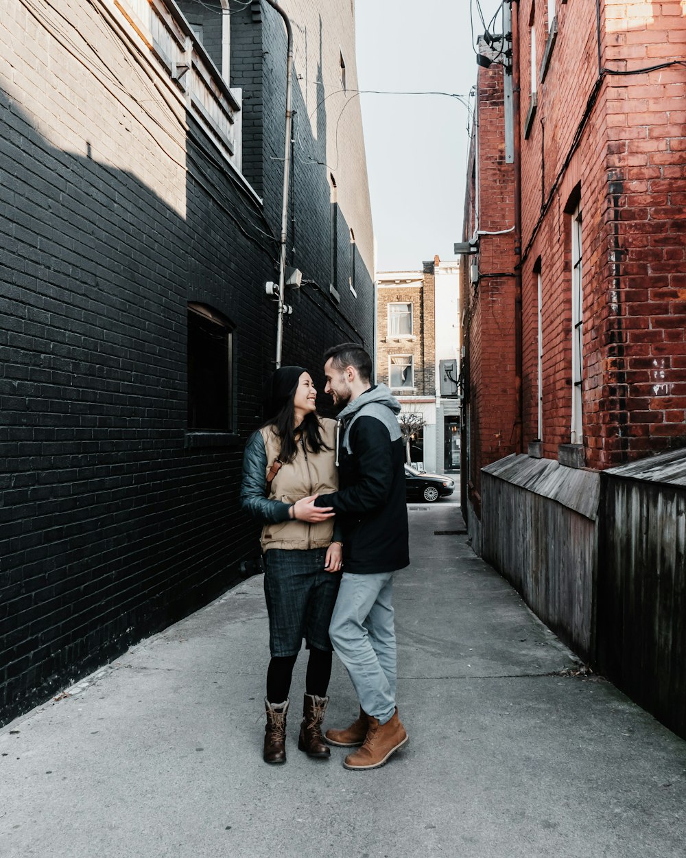 man and woman standing near building