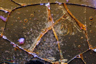 Abstract graphic showing precision crack filling lines glowing in orange and white on a black background.