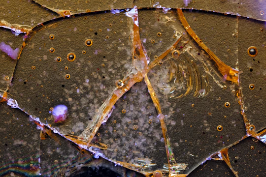 Abstract graphic showing precision crack filling lines glowing in orange and white on a black background.