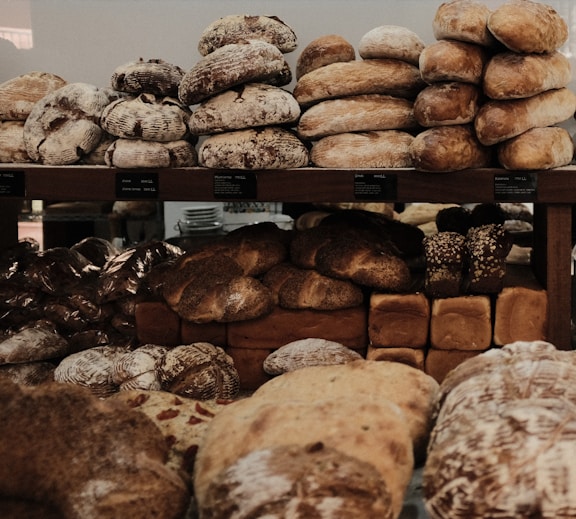 baked breads on brown wooden rack