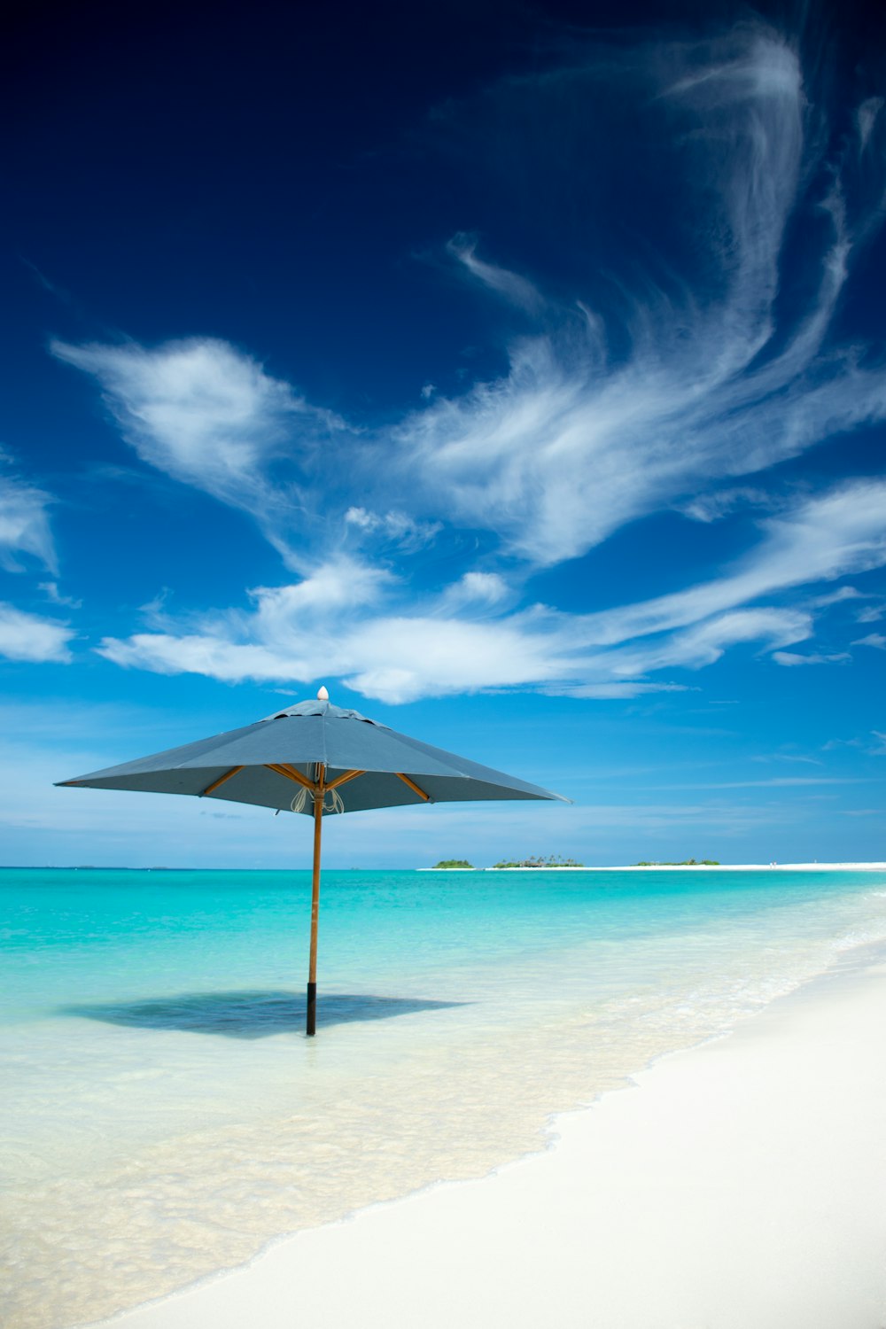 gray parasol on seashore during daytime