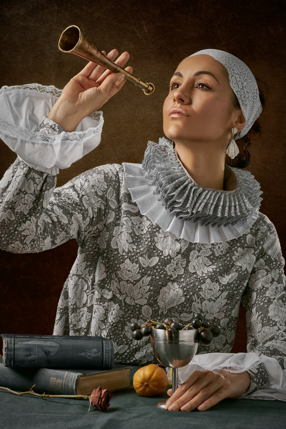 man in white lace long-sleeved shirt holding trumpet