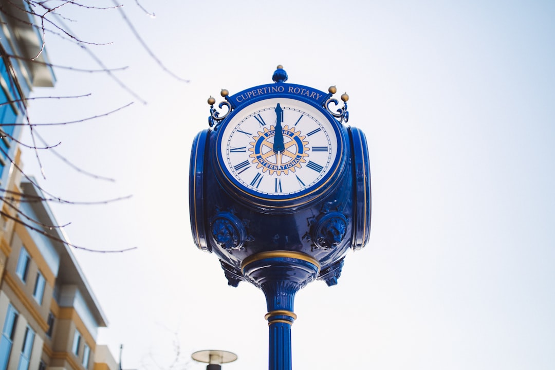 blue metal numeric clock during daytime