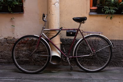 bicycle leaning on wall near trash bin photo – Free Image on Unsplash