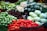 A vibrant display of fresh fruits and vegetables in a supermarket aisle.