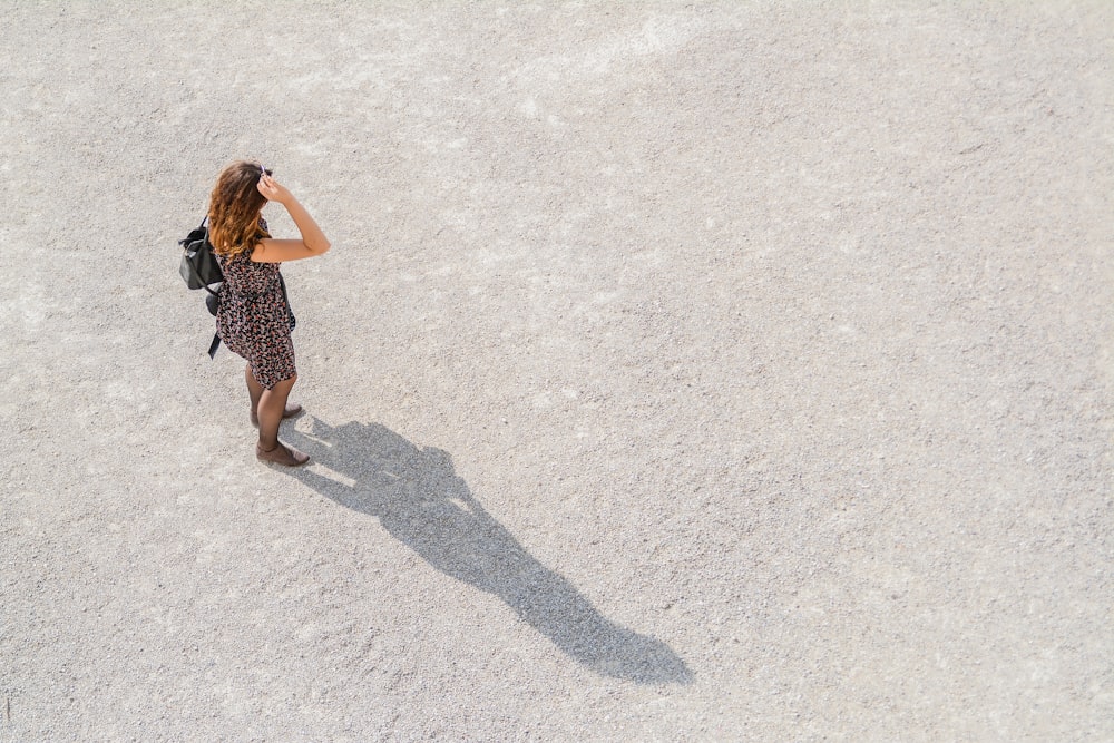 woman standing while carrying backpack