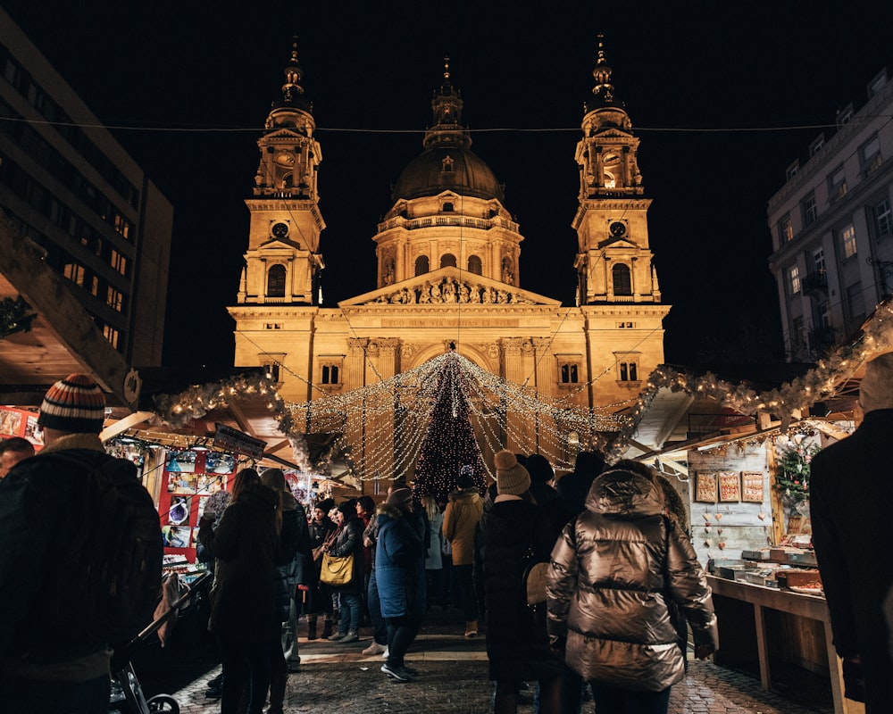 people gathered outside buildings at night