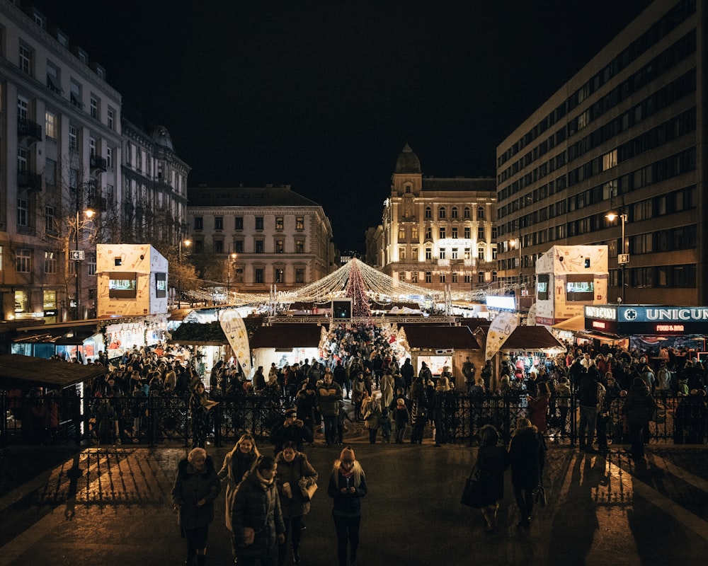 people near lighted tent at night