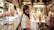 A smiling customer standing in a beautifully designed interior space.