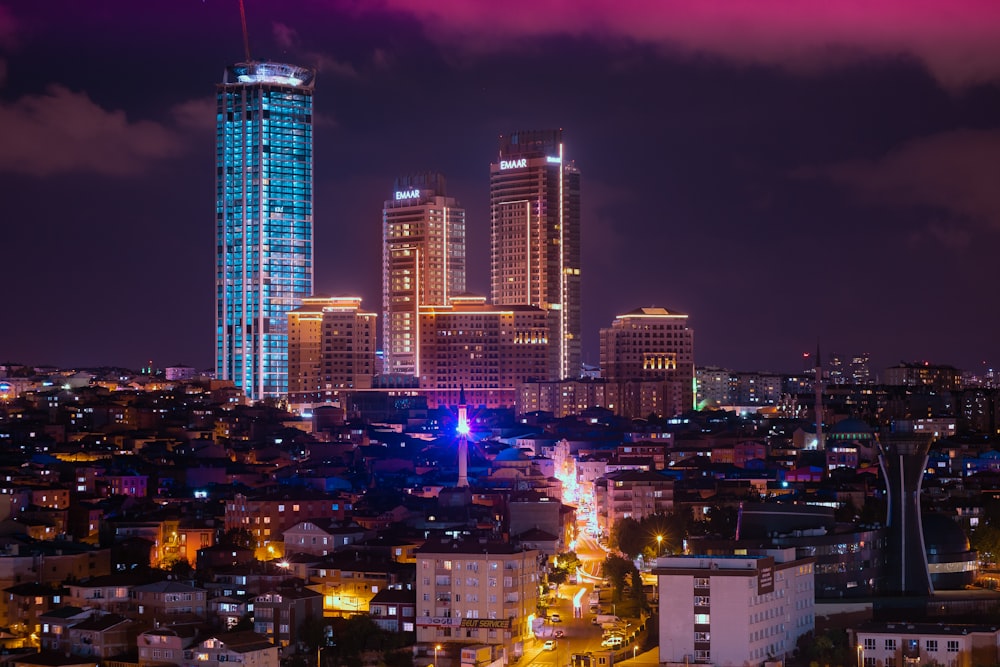 aerial photography of city with high-rise buildings at night time