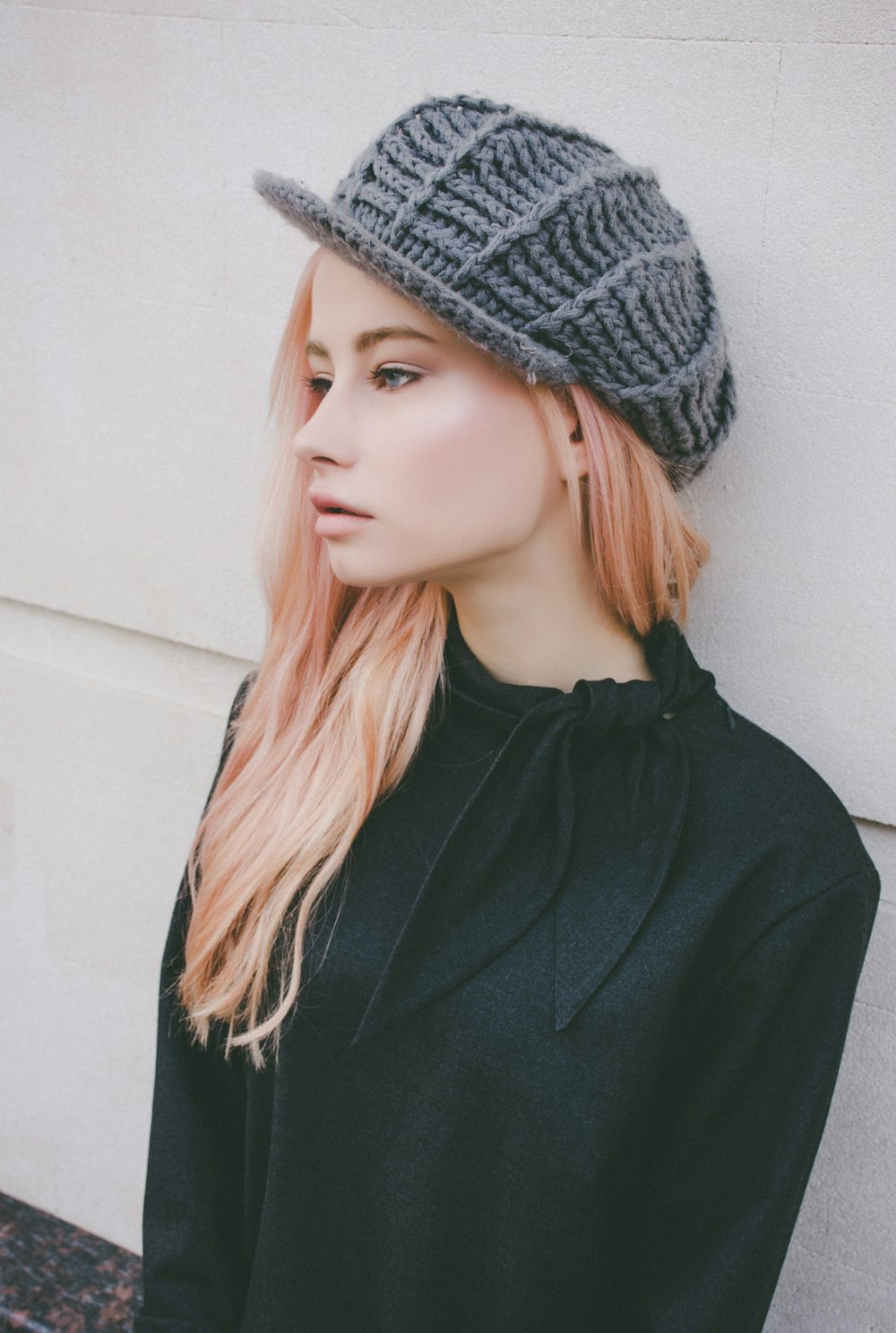 woman leaning on wall