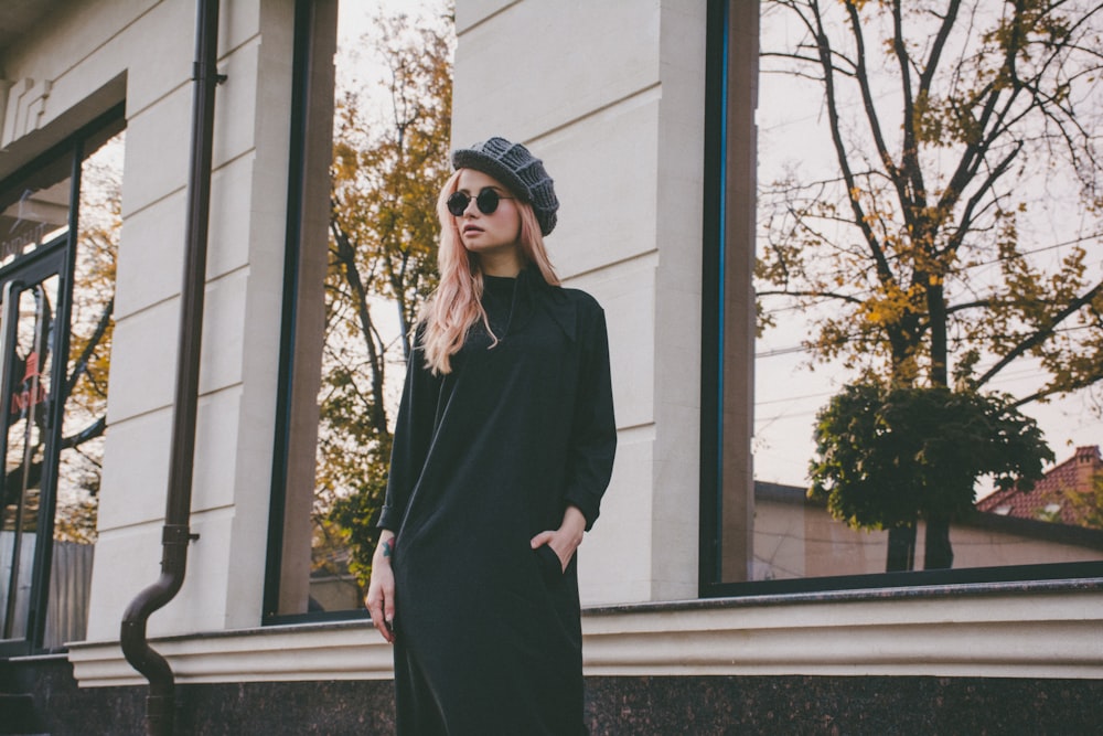 woman standing near glass window building