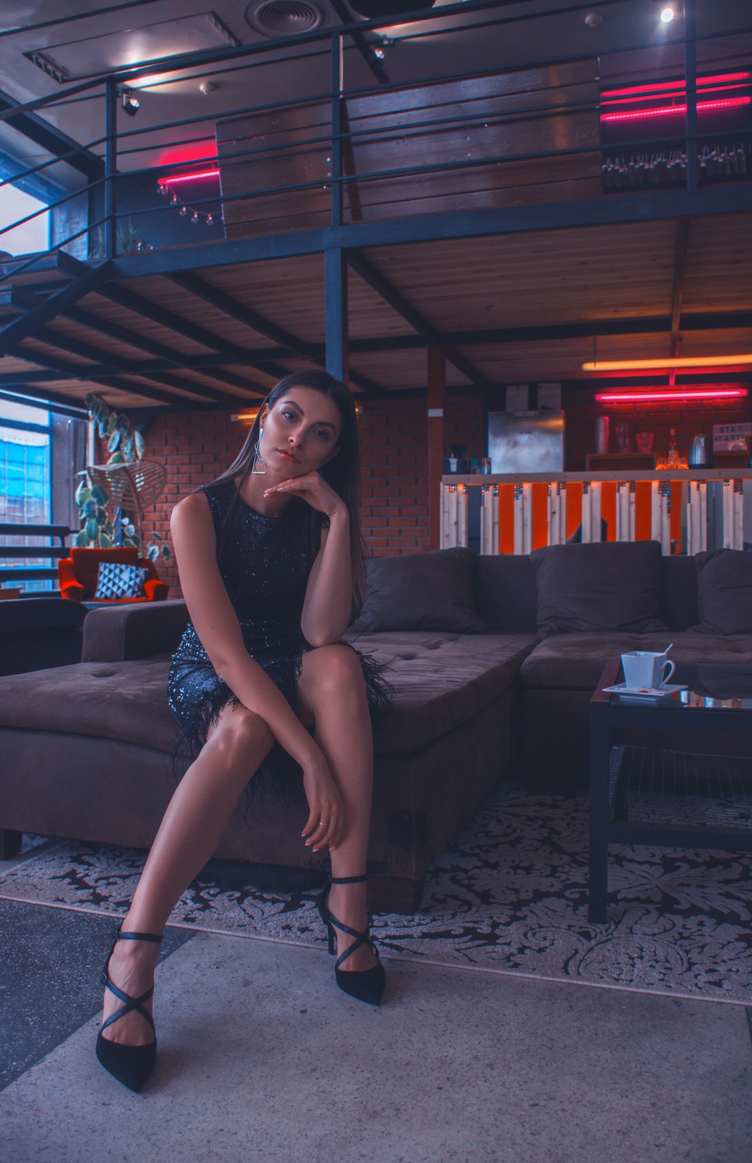 woman sitting on brown sectional couch