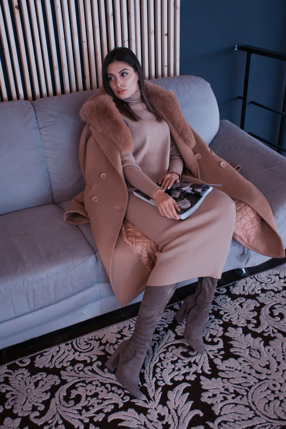 woman sitting on sofa holding book