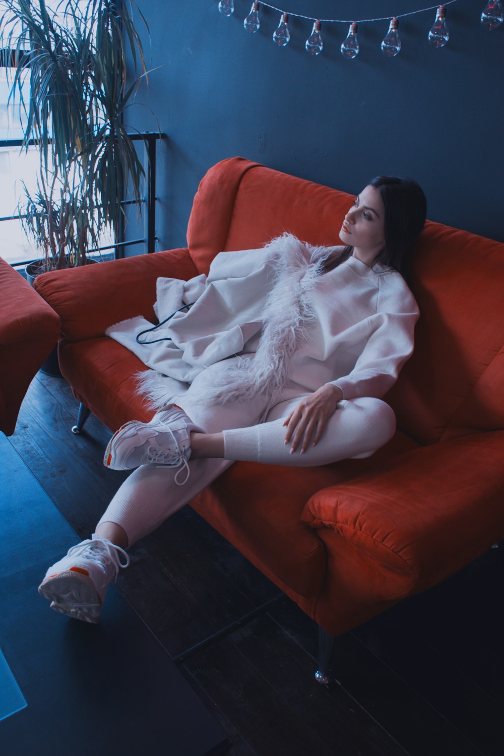 woman sitting on sofa with cross legs