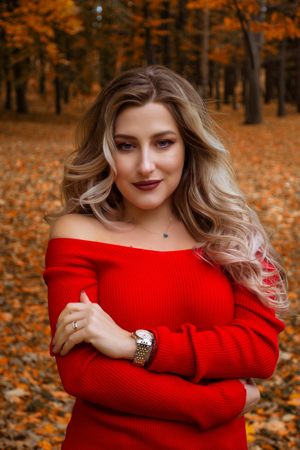 shallow focus photo of woman in red off-shoulder long-sleeved shirt