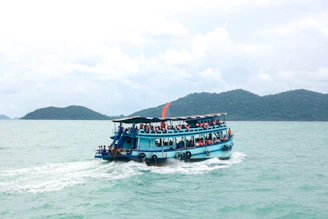 A family enjoying a scenic ferry ride across turquoise Caribbean waters.