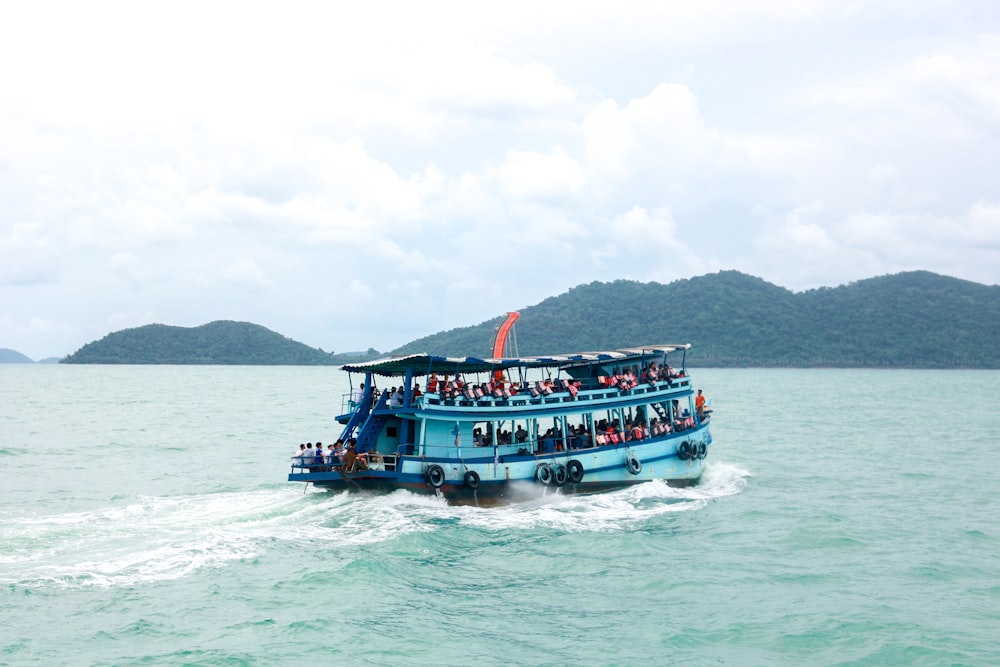 people riding boat on body of water during daytime