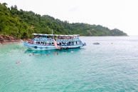 Family enjoying a traditional boat ride in Labuan Bajo surrounded by clear blue waters.