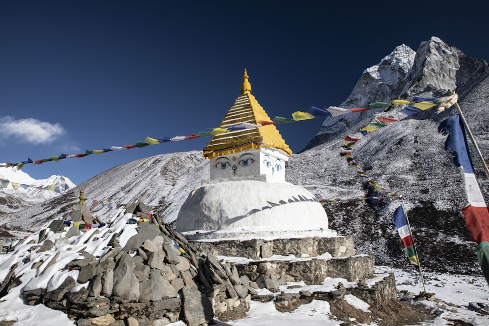 yellow and white painted building near mountain