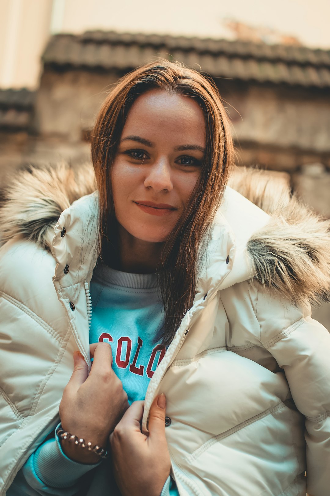 smiling woman wearing grey and white parka jacket