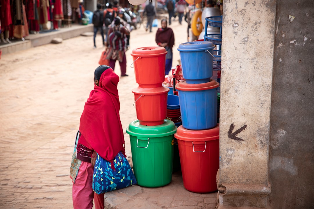 person standing near pile of plastic containers