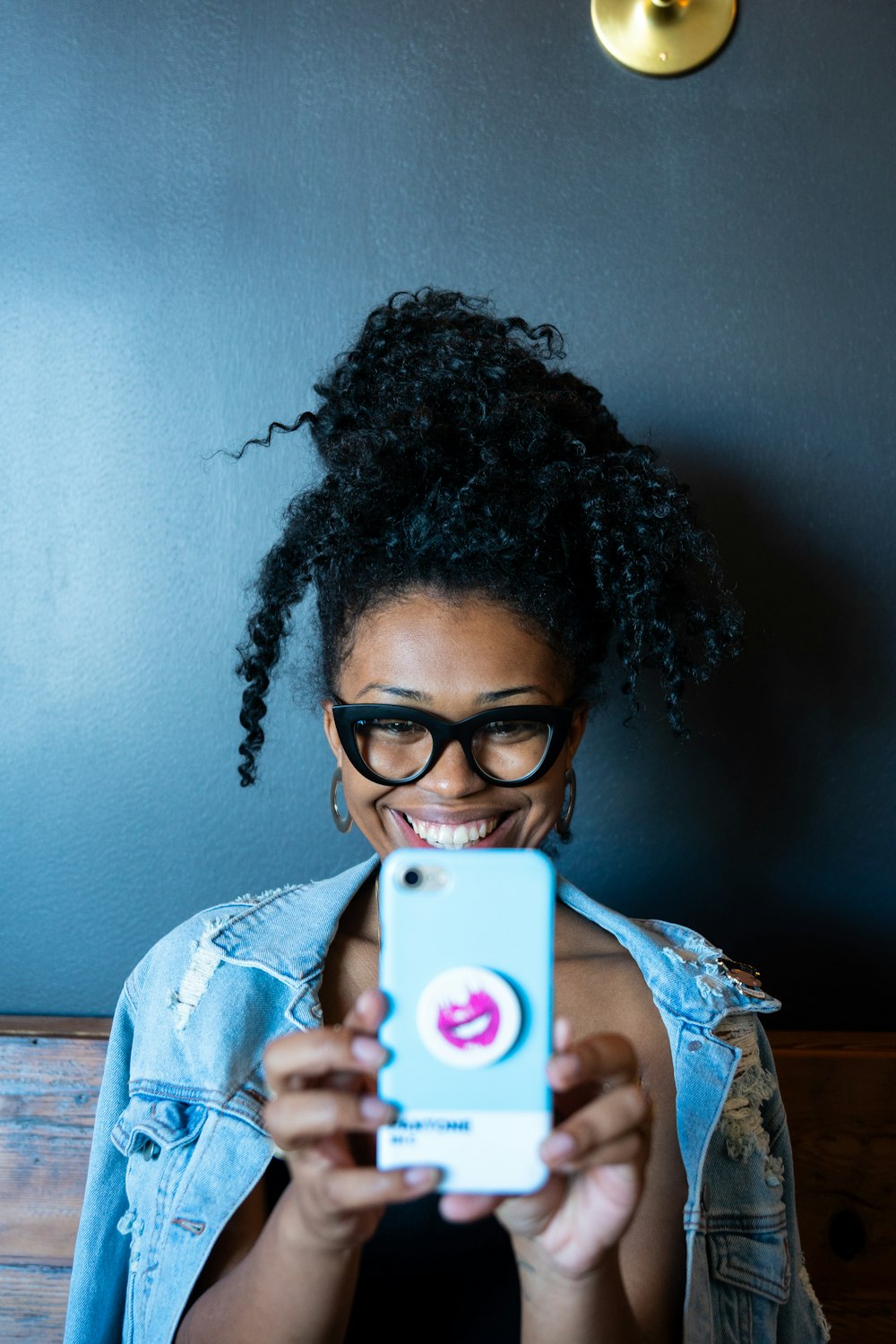 smiling woman while holding smartphone