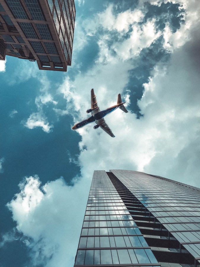 Airplane, skyscrapper, clouds