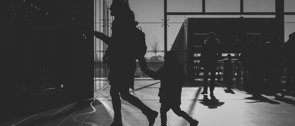 silhouette of woman holding child