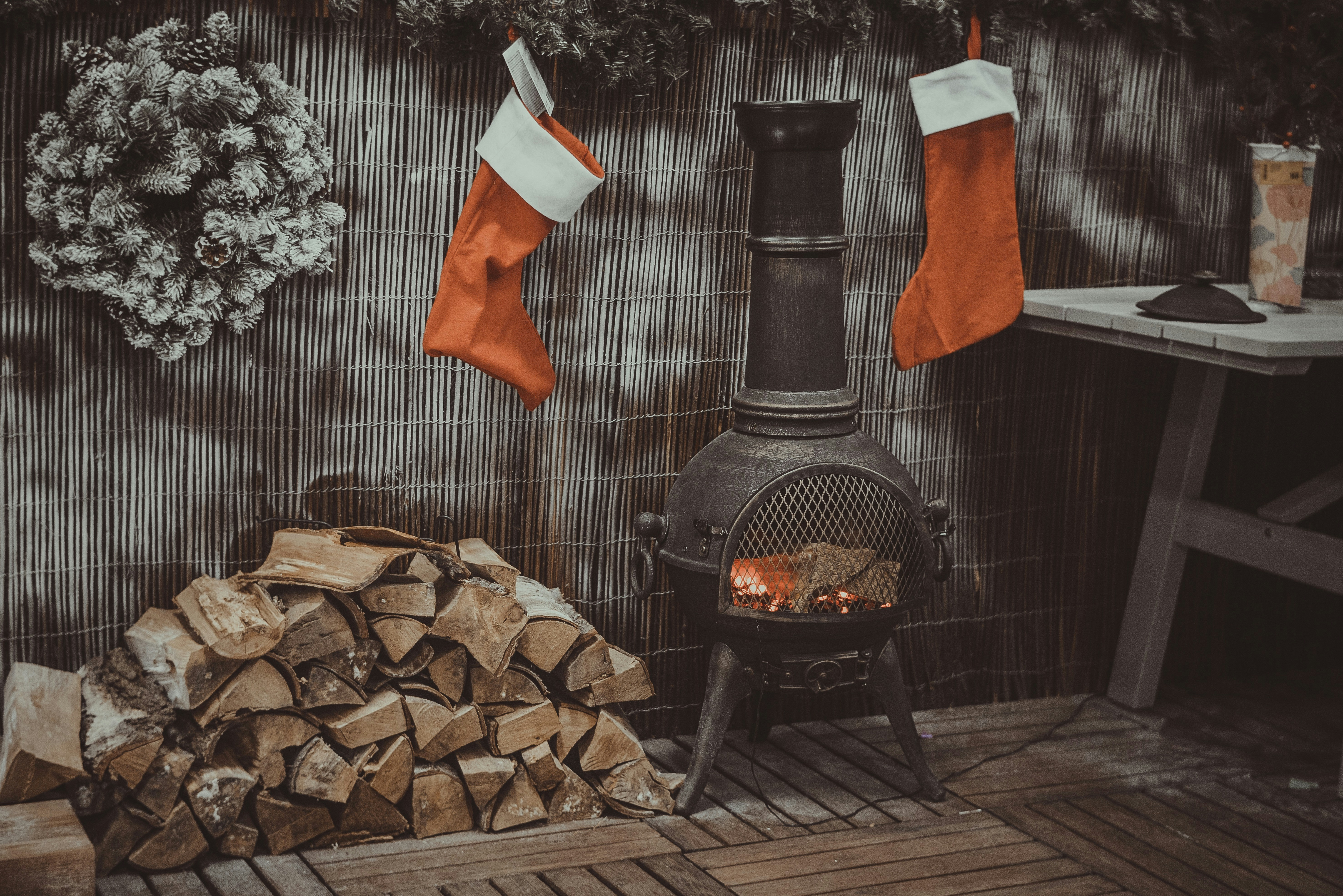 firewood in black chiminea stocking teams background