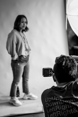 man taking photo of woman standing